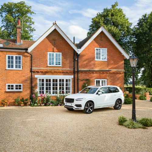 Large executive mansion house and luxury car in a rural setting, Buckinghamshire, England, UK