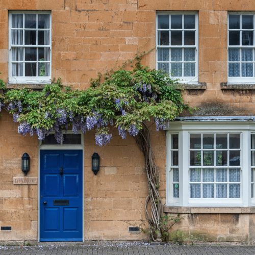 BROADWAY, ENGLAND - MAY, 27 2018: Pretty Cottages with climbing