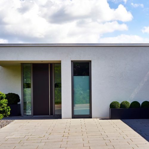 Entrance area of a modern city villa in minimalist design, view from public ground