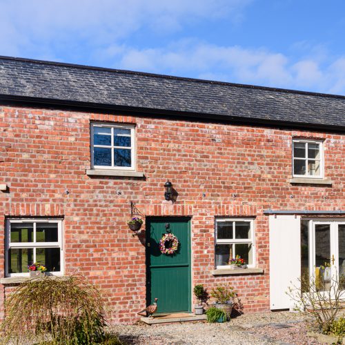 Pretty converted Irish barn house cottage with stable door and sliding barn doors.
