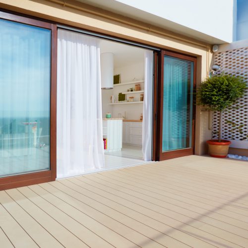 roof top patio with open space kitchen, sliding doors and decking on upper floor